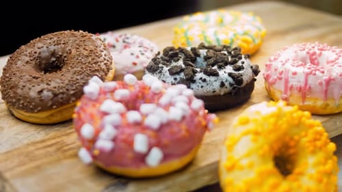 Colorful Donuts on Wooden Board