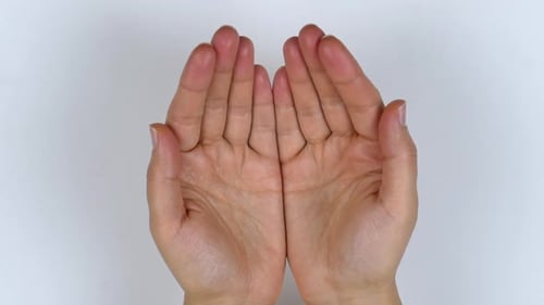 Woman's hands open. A view from above of the palm closure.