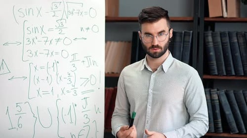 Male Tutor Explaining Equations on Whiteboard