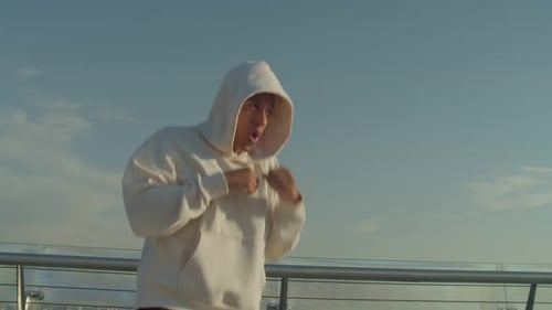 Young Adult Boxing Workout on a City Bridge