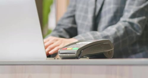 Close up customer hand credit card scanner machine at cashier