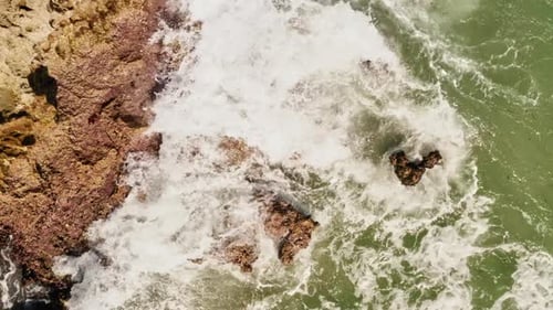 Waves Crashing on Rocky Coast from Above