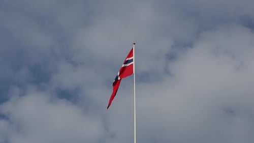 National Flag Waving Against Cloudy Sky