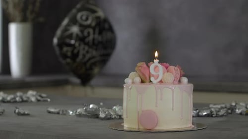 Celebratory Birthday Cake with Candle and Balloon