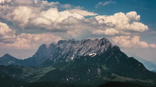 Timelapse scenery with mountain peaks and cloudy sky. Amazing landscape on mountain.