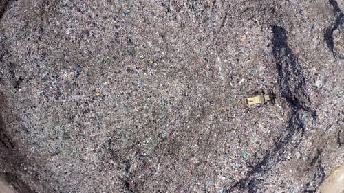 Aerial View of Landfill with Bulldozer Compacting Waste