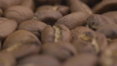 Abstract macro close up of roasted coffee beans, slow zoom out