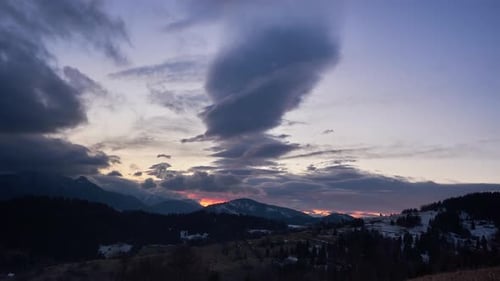 Beautiful dusk over the mountain landscape, day to night. Beautiful colors of clouds