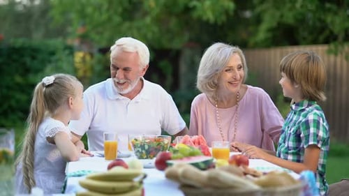 Happy Family Enjoying Outdoor Meal Together