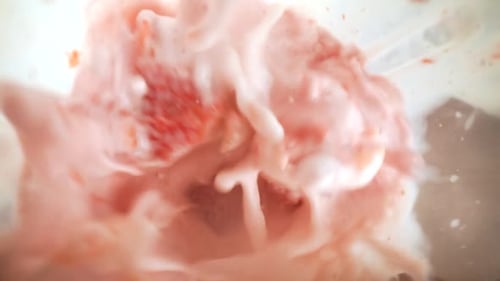 Strawberries Being Blended Into a Pink Smoothie