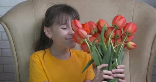 Happy Girl with Bouquet of Tulips Indoors