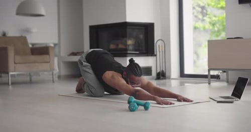 Adult Doing Yoga on Yoga Mat at Home