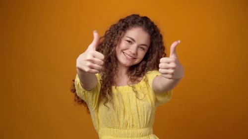 Smiling Woman Gives Two Thumbs Up