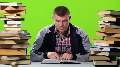 Guy That's Fun Reading and Leafing Through the Book. Green Screen