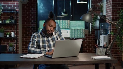 Male Analyst Talking on Phone Call About Market Exchange Information