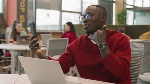 Young Adult on Video Call in Modern Office