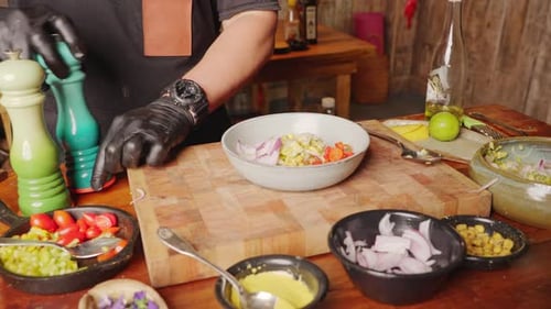 Chef Adds Ingredients to Bowl for Healthy Dish