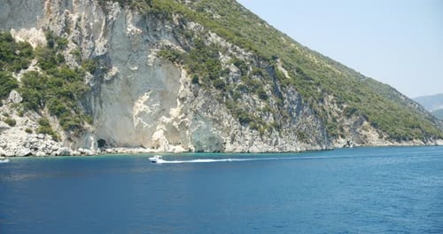 Pleasure Speed Boat in Open Blue Sea with Beautiful Ionian Island in Background