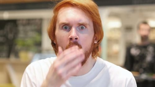 Man Reacting in Shock, Covering Eyes