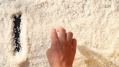 Hand Draws "I Love Food" in Rice Grains