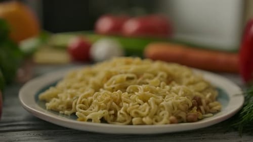 Plate of Steaming Noodles with Fresh Vegetables
