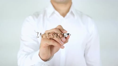 Man Writes Investors on Clear Surface with Marker