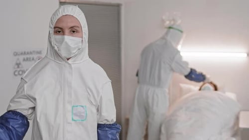 Healthcare Workers in PPE in Hospital Room