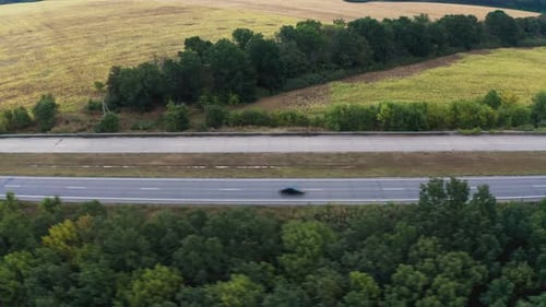 Long Twolane Concrete Road with Traffic in Rural Area