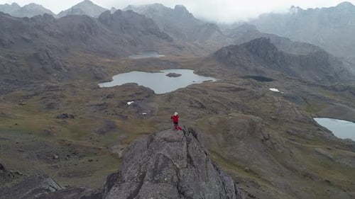 Man Climbing High Hill Mountains and Lakes