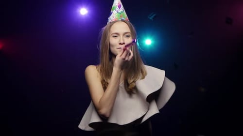 Girl Blows Off Confetti with Palms, Blowing Party Whistle, Dancing