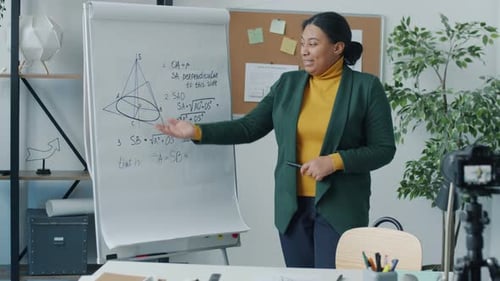 Woman Explains Math Equations on Whiteboard