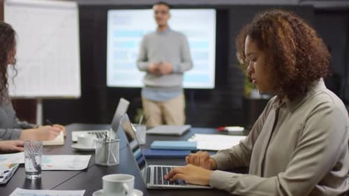 Professional Team Attending Presentation in Modern Office