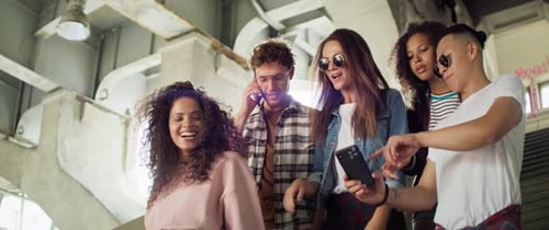 Trendy Young Adults With Smartphones in Urban Setting