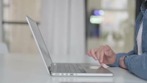 Close Up of Male Hand Working on Laptop