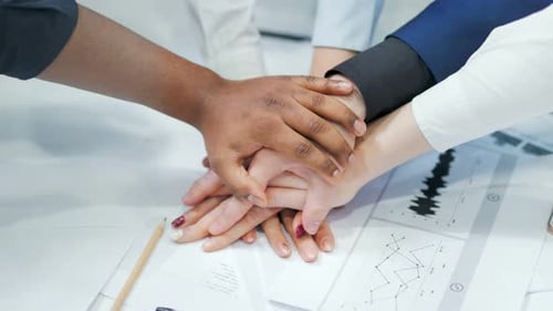 Diverse Team Stacking Hands in Unity and Support