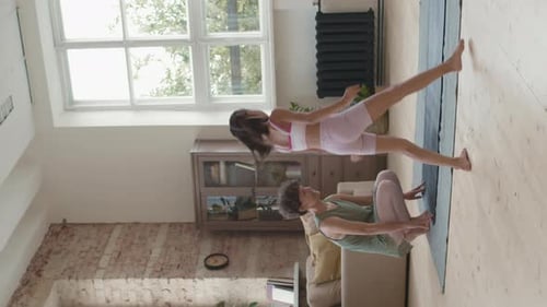 Woman and Girl Exercising Together on Yoga Mat