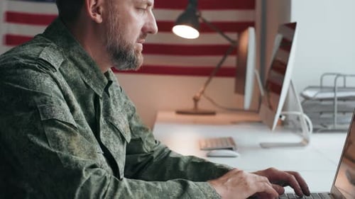 Army Officer Working on Laptop in Office