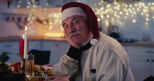 Lonely Senior Man With Santa Hat On Christmas