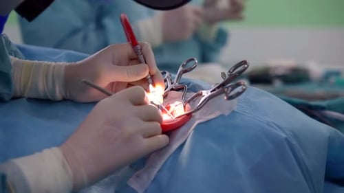 Close-up View of Ear of Patient in Surgery Room, Extenders Are Fixing, Installing a Hearing Aid