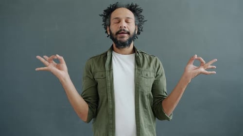 Slow Motion Portrait of Enlightened Mixed Race Man Meditating Holding Hands in Namaste Gesture