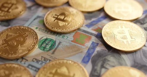 Close Up of Bitcoin Coins on US Dollars