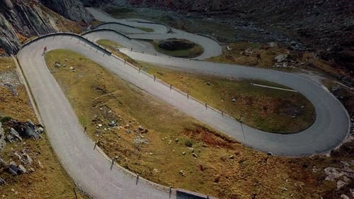 Road Cyclist Climbs Up Sunset Mountain Switchbacks