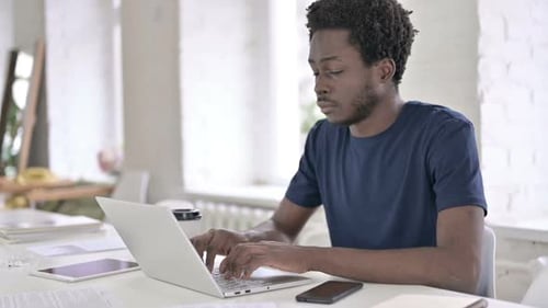 Man Working on Laptop in Modern Office