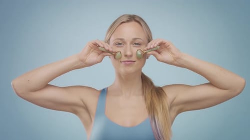 Woman Uses Jade Facial Rollers in Studio