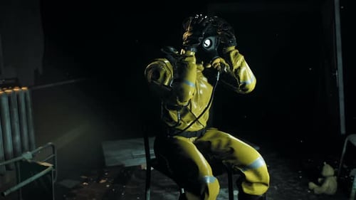 Distressed Person in Hazmat Suit in Dark Abandoned Room