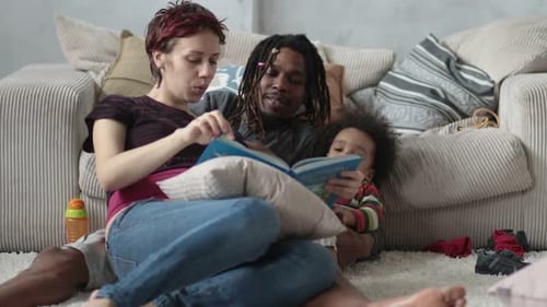 Family Reading a Book Together in Living Room