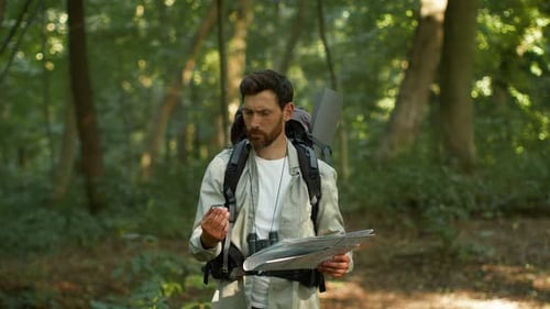 Active Man Tourist Got Lost During Hiking Trip in Woodland Looking for Right Way with Compass and