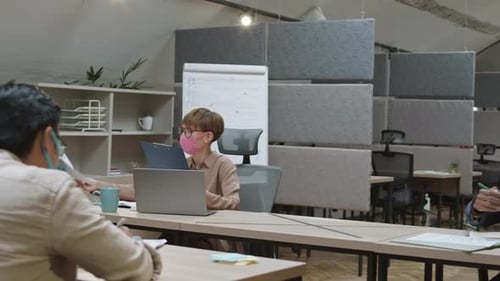 Three Young Businesspeople Keeping Social Distance in Office