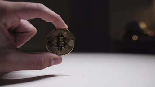 Hand Holding Bitcoin, Close Up on Currency