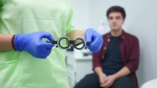 Eye Exam Glasses Held by Doctor in Clinic